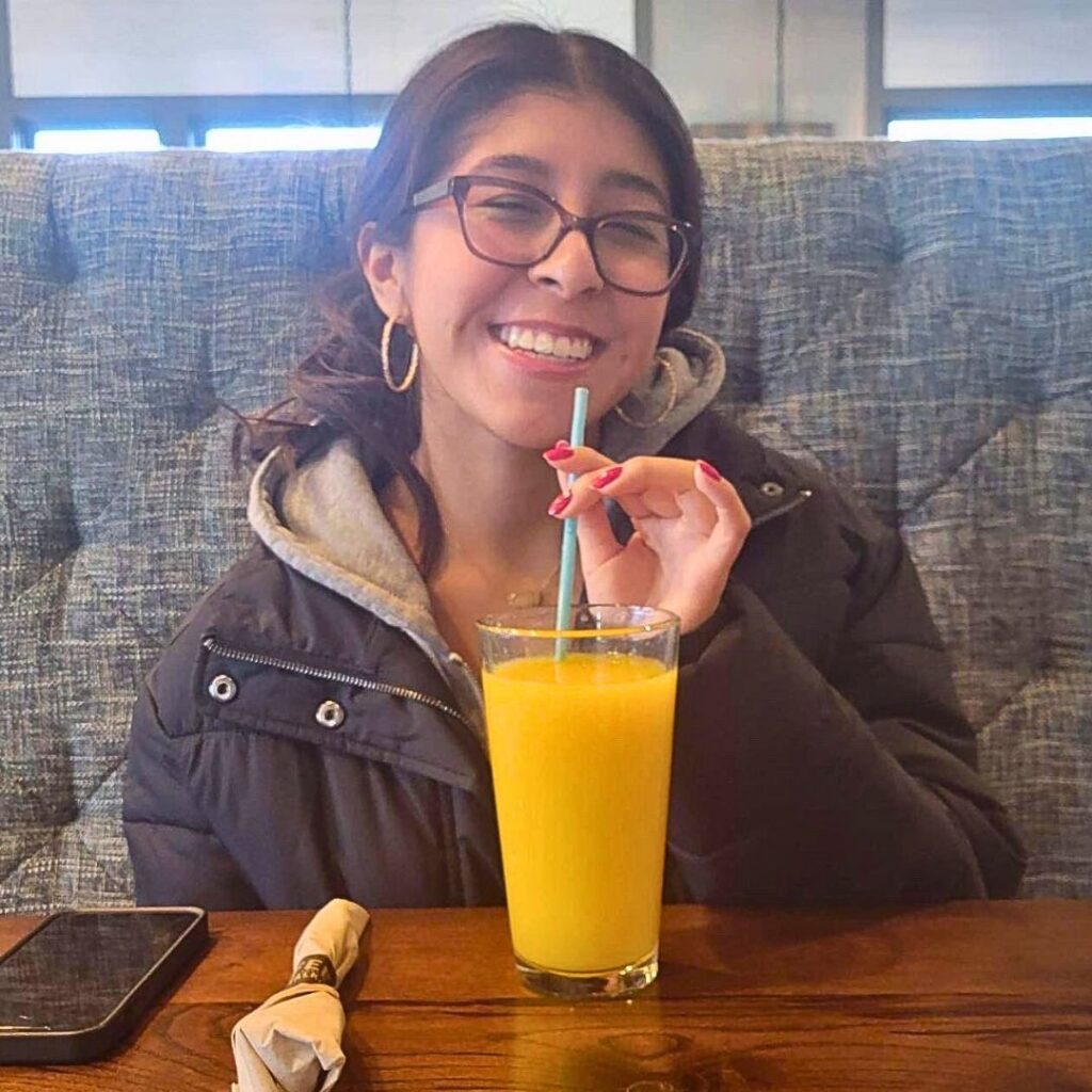 A photo of Jocelyn drinking juice at a restaurant.