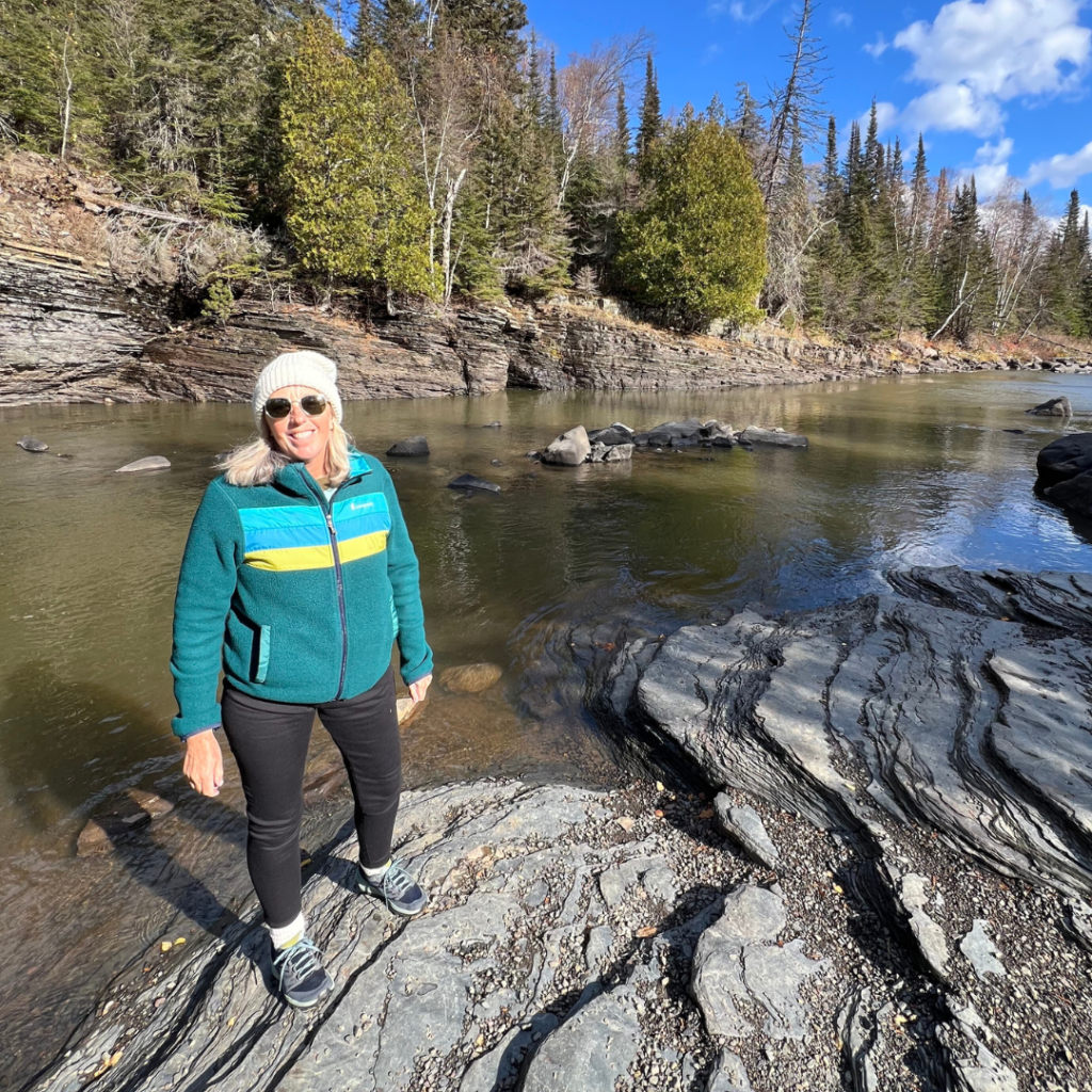 DeDe standing by the riverbank